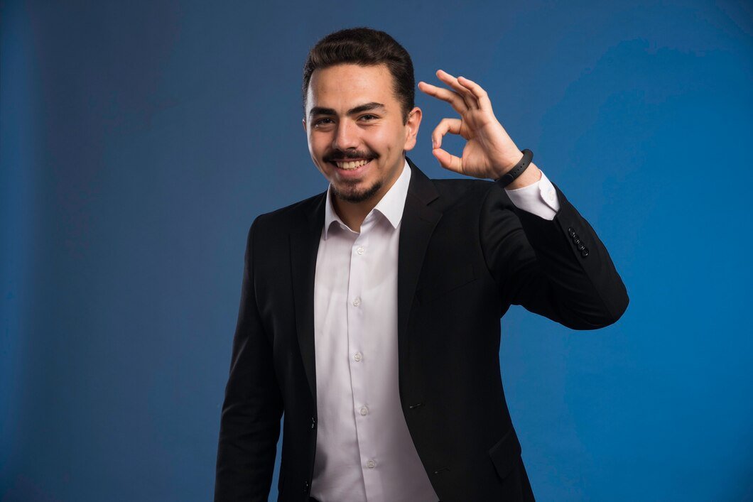 businessman-black-suit-makes-positive-sign_114579-15886