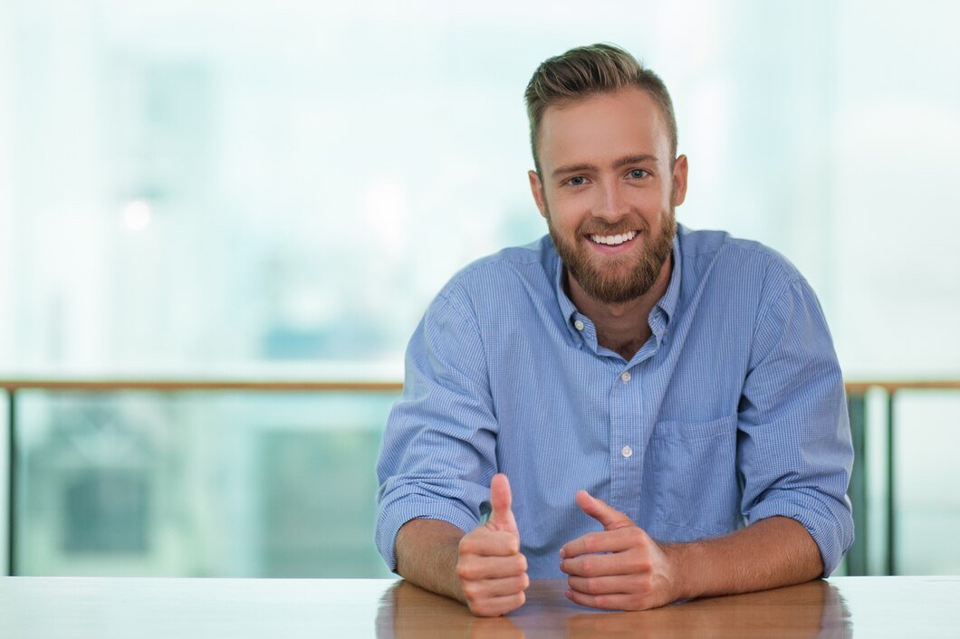 smiling-man-sitting-cafe-table-gesturing_1262-1141